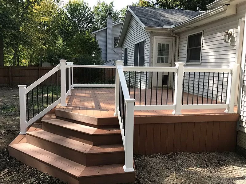 Custom composite deck with white railing built by Braun Construction on Cape Cod