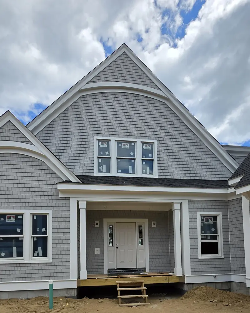Gray cedar shingle siding with white trim installed by Braun Construction on a home in Centerville, MA